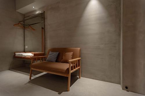 a chair sitting in a room with a table at 全村的希望Hope of village in Dongshan