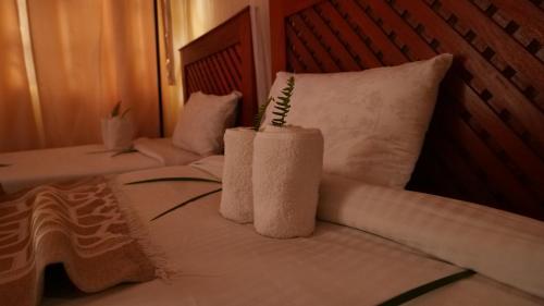 a hotel room with two towels on a bed at Vijiji Center Lodge and Safari in Arusha