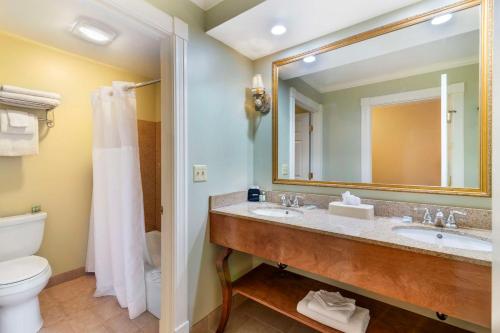 a bathroom with a sink and a toilet and a mirror at Best Western White House Inn in Bangor