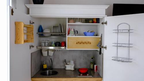 a kitchen with a sink in a small room at Rooms Apartaments Santa Teresa in Capo Testa