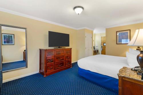 a hotel room with a bed and a television at Best Western White House Inn in Bangor