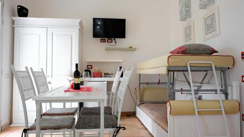 a small room with two bunk beds and a table at Rooms Apartaments Santa Teresa in Capo Testa