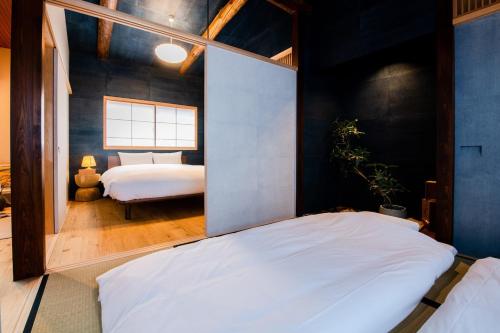 Postel nebo postele na pokoji v ubytování KACHŌ Serenity