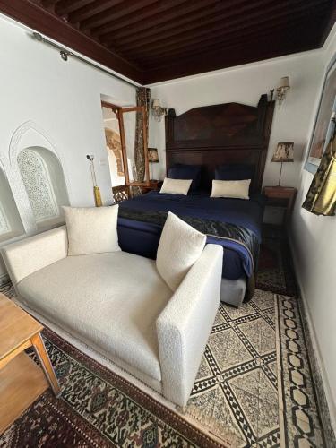 a bedroom with a bed and a couch at Dar Tya Rabat Salé Marina in Sale