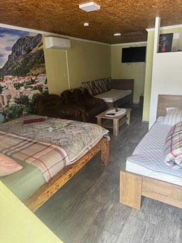 a living room with two beds and a couch at Motel Capljina in Čapljina