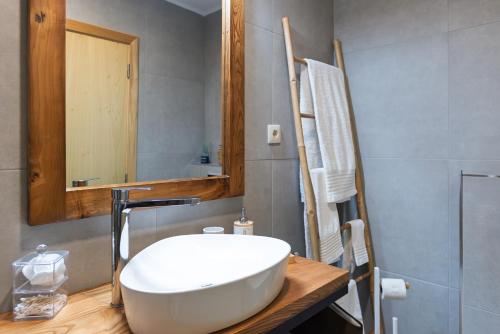 a bathroom with a white sink and a mirror at Feel Discovery Casa do Alfaiate in Peso da Régua