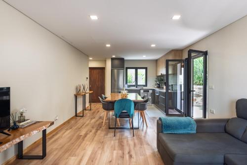 a kitchen and living room with a couch and a table at Feel Discovery Casa do Alfaiate in Peso da Régua