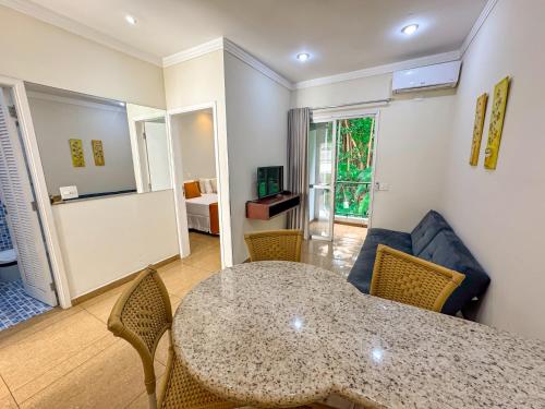 a living room with a table and chairs at Hotel Nacional Inn Guarujá in Guarujá