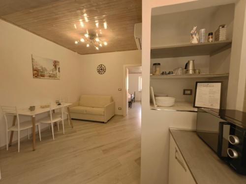 a kitchen and living room with a table and a dining room at Caruggi Lifestyle - mare 200m - AC - WiFi in Albissola Marina