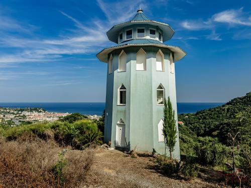 a lighthouse sitting on top of a hill at Caruggi Lifestyle - mare 200m - AC - WiFi in Albissola Marina