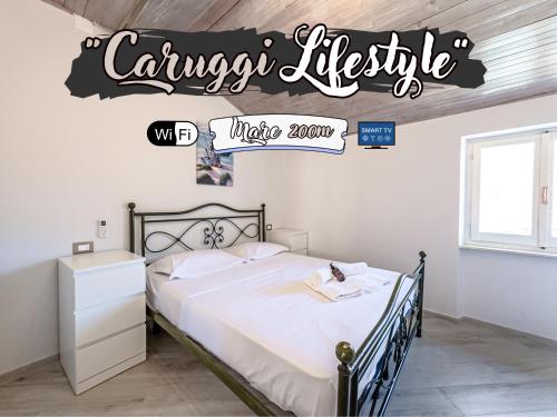 a bedroom with a bed with a sign that reads canyon lifestyle make room at Caruggi Lifestyle - mare 200m - AC - WiFi in Albissola Marina