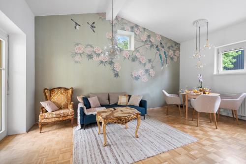 a living room with a blue couch and a table at Studio Apartment Graz Schloss Eggenberg in Graz