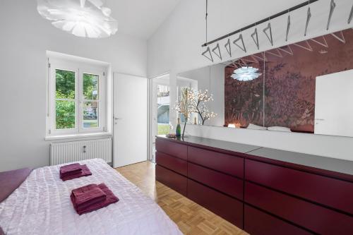 a bathroom with a large vanity and a large mirror at Studio Apartment Graz Schloss Eggenberg in Graz