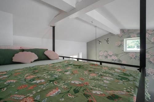 a bedroom with a bed with a floral bedspread at Studio Apartment Graz Schloss Eggenberg in Graz