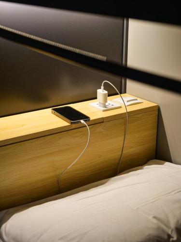 a bedroom with a bed with a wooden head board at Marathon Hostel in Genova