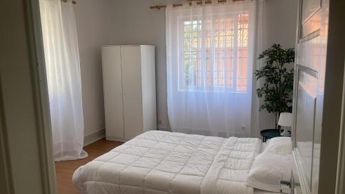 a bedroom with a white bed and a window at Residencial Sky Lounge in Lisbon