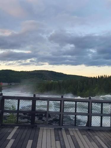 a view of a river from a wooden pier at Fjällnära Villa i Vidsel in Vidsel