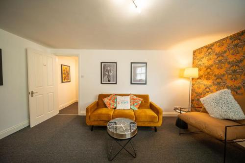 a living room with a couch and a table at Cotswolds, 2Bed 1 Bath Historic Flat, Very Central in Cirencester