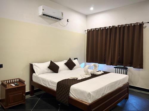 a bedroom with two beds and a air conditioner at DIVINE BEACH INN - The sea shore hotel in Puducherry