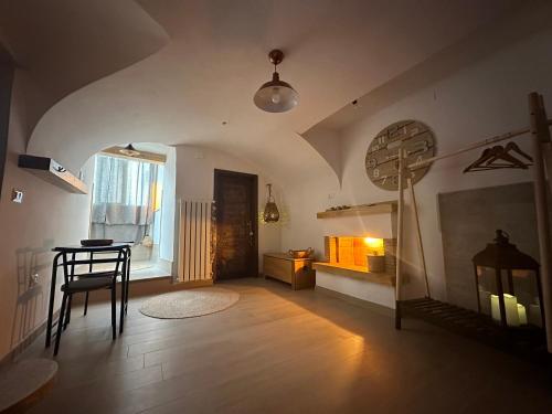 a living room with a table and a chair in it at Mariella Vernile in Civitella Roveto