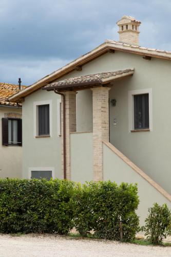a white house with a chimney on top of it at Retrocantina Antonelli in Montefalco