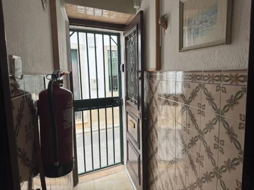 an open door with a fire hydrant in a room at Beautiful 3-Bed House in Tavira In the city center in Tavira