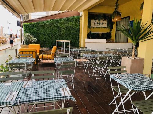 a group of tables and chairs on a patio at Hôtel les 4 éléments in Palavas-les-Flots