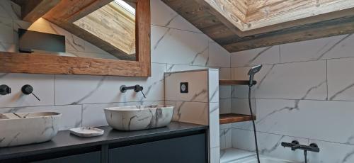 une salle de bain avec deux lavabos sur un comptoir dans l'établissement Appartement 3 chambres lumineux avec extérieur, à La Clusaz