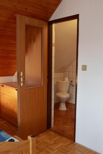 an open door to a bathroom with a toilet at Ubytování U Anděla in Raby
