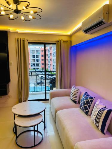 a living room with a couch and a table at Cozy Studio near Airport in Pusok