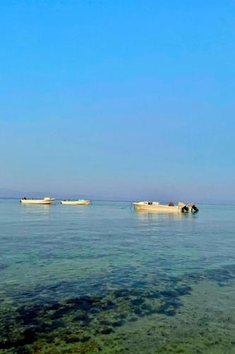 three boats floating in the water in the ocean at Lucky palace Dahab in Dahab