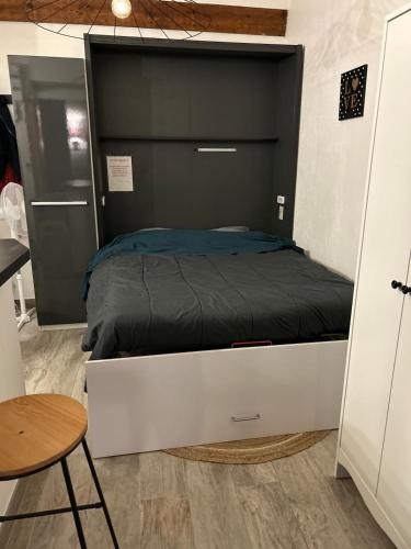 a bedroom with a large bed with a black headboard at Cottage, private terrace in La Rochelle in La Rochelle
