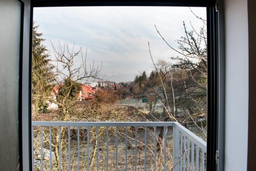 a window with a view of a yard at Villa Ľadoveň LUXUSNÝ APARTMÁN 124m2 in Martin