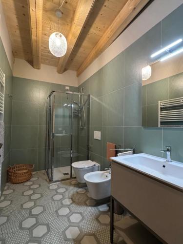 a bathroom with a tub and a toilet and a shower at La Maison du Lac Iseo 2 in Predore