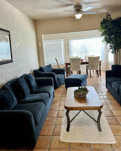 a living room with blue couches and a table at Historic Home near the water - perfectly walkable spot! in Lake Worth