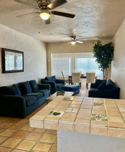a living room with blue couches and a table at Historic Home near the water - perfectly walkable spot! in Lake Worth
