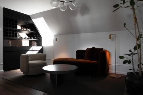 a living room with a couch and a chair at Park Lane Copenhagen in Hellerup