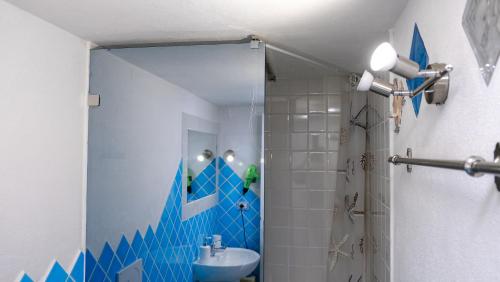 a bathroom with a toilet and a sink and a shower at Rooms Apartaments Santa Teresa in Capo Testa
