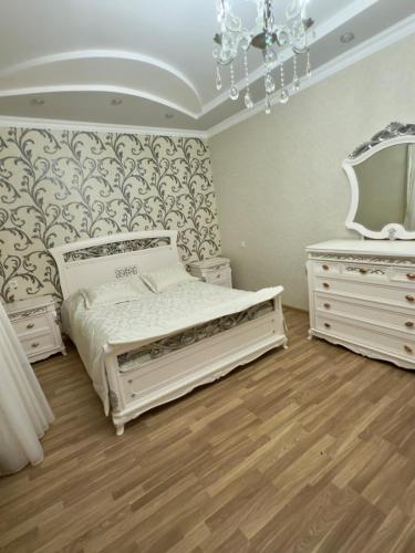 a bedroom with a bed and two dressers and a mirror at Dream house in Yeghegnadzor