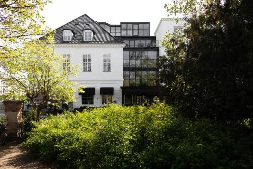 a white building with a black roof at Park Lane Copenhagen in Hellerup