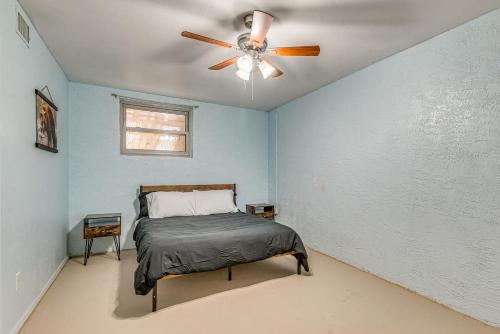 a bedroom with a bed and a ceiling fan at 4 Mi to Museums Roswell Getaway with Game Room! in Roswell