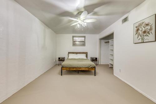 a bedroom with a bed and a ceiling fan at 4 Mi to Museums Roswell Getaway with Game Room! in Roswell