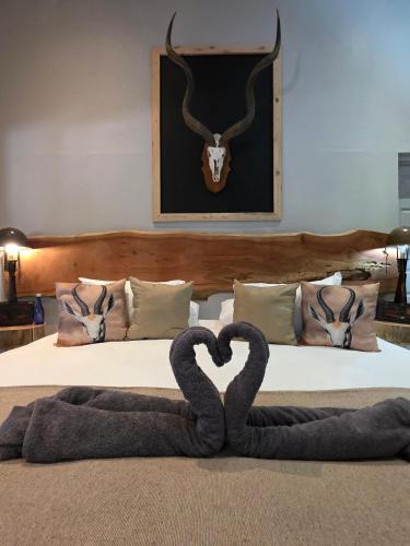 a bedroom with a bed with a snake on it at Ukulala Inn in Malelane