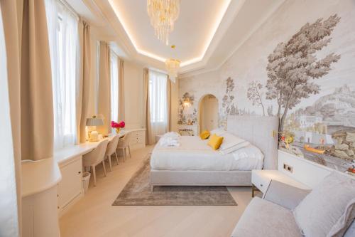 a bedroom with a bed and a desk in a room at Hotel Belvedere in Forte dei Marmi