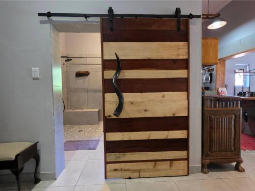 a sliding barn door in a room with a shower at Ukulala Inn in Malelane