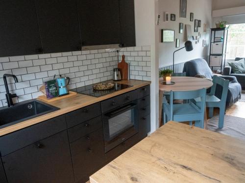 a kitchen with a sink and a table in a room at Cosy loft apartment w sauna & Pyhätunturi view in Pyhätunturi