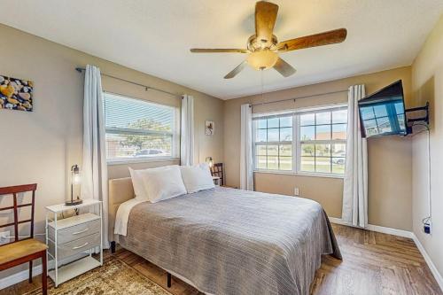 a bedroom with a bed and a ceiling fan at The Coastal Caddy in Rotonda West