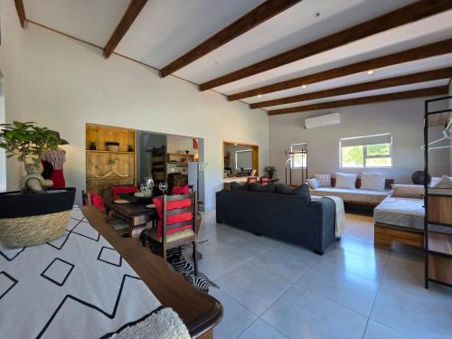 a living room with a couch and a table at Ukulala Inn in Malelane