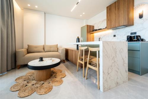 a kitchen and living room with a table and a couch at Haven Luxury Living in Chaïdeftón