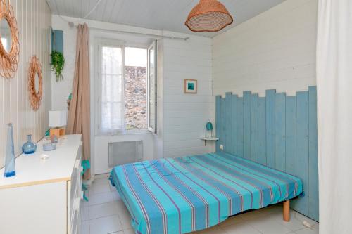 Un dormitorio con una cama azul en una habitación. en Nid Douillet Entre Plage Et Port, en Le Pouliguen